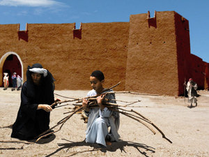 As he got near the city gate he looked around and saw a woman
gathering sticks