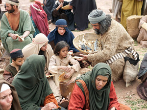 They scattered themselves around the crowd and started passing out pieces of fish and pieces of bread