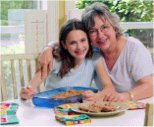 Mom and daughter go to the kitchen and have a cookie