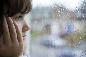 Yasha looking through the window at the rain drops